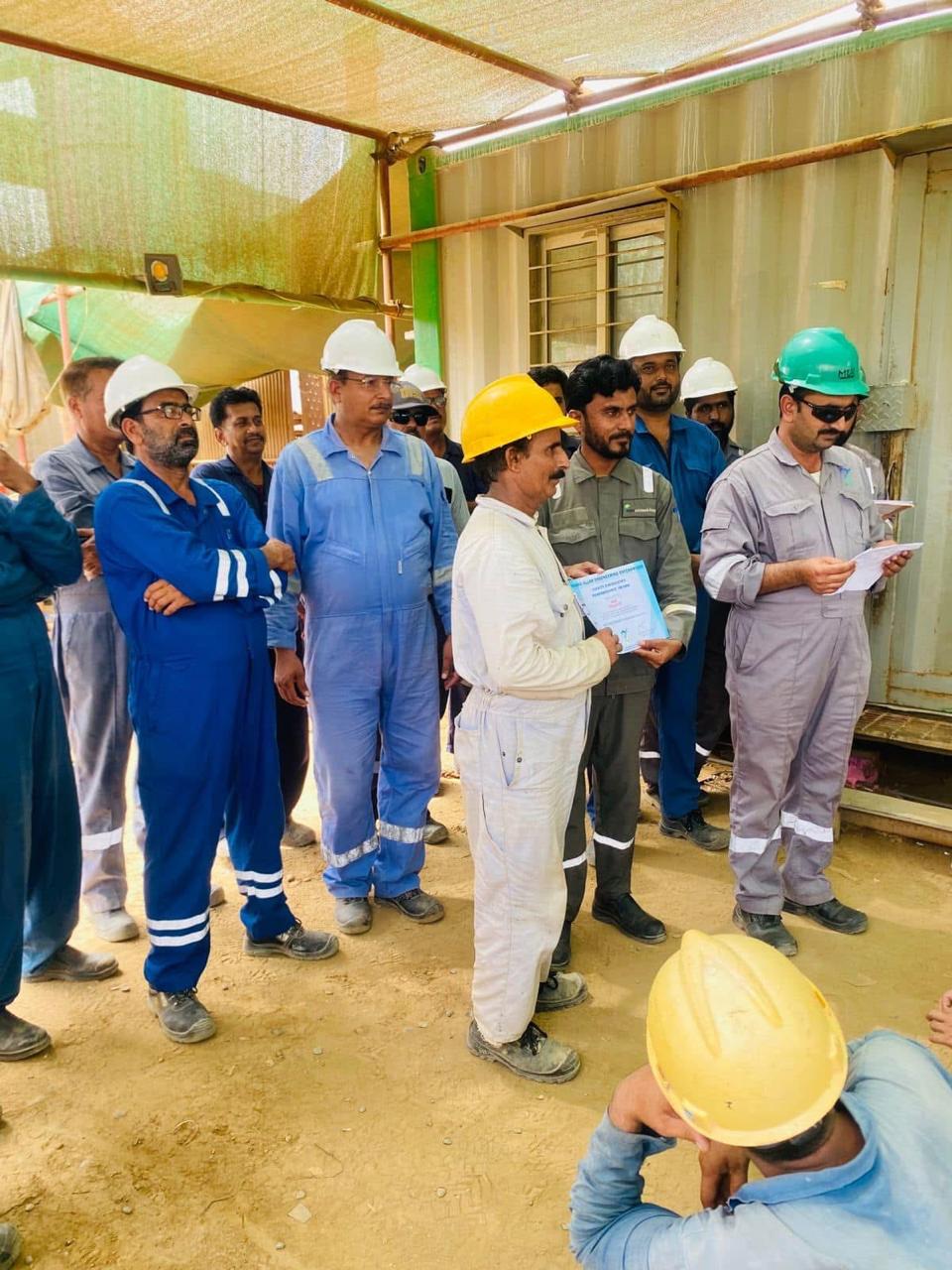 MEEC engineers reviewing drawings on a steel fabrication workshop floor