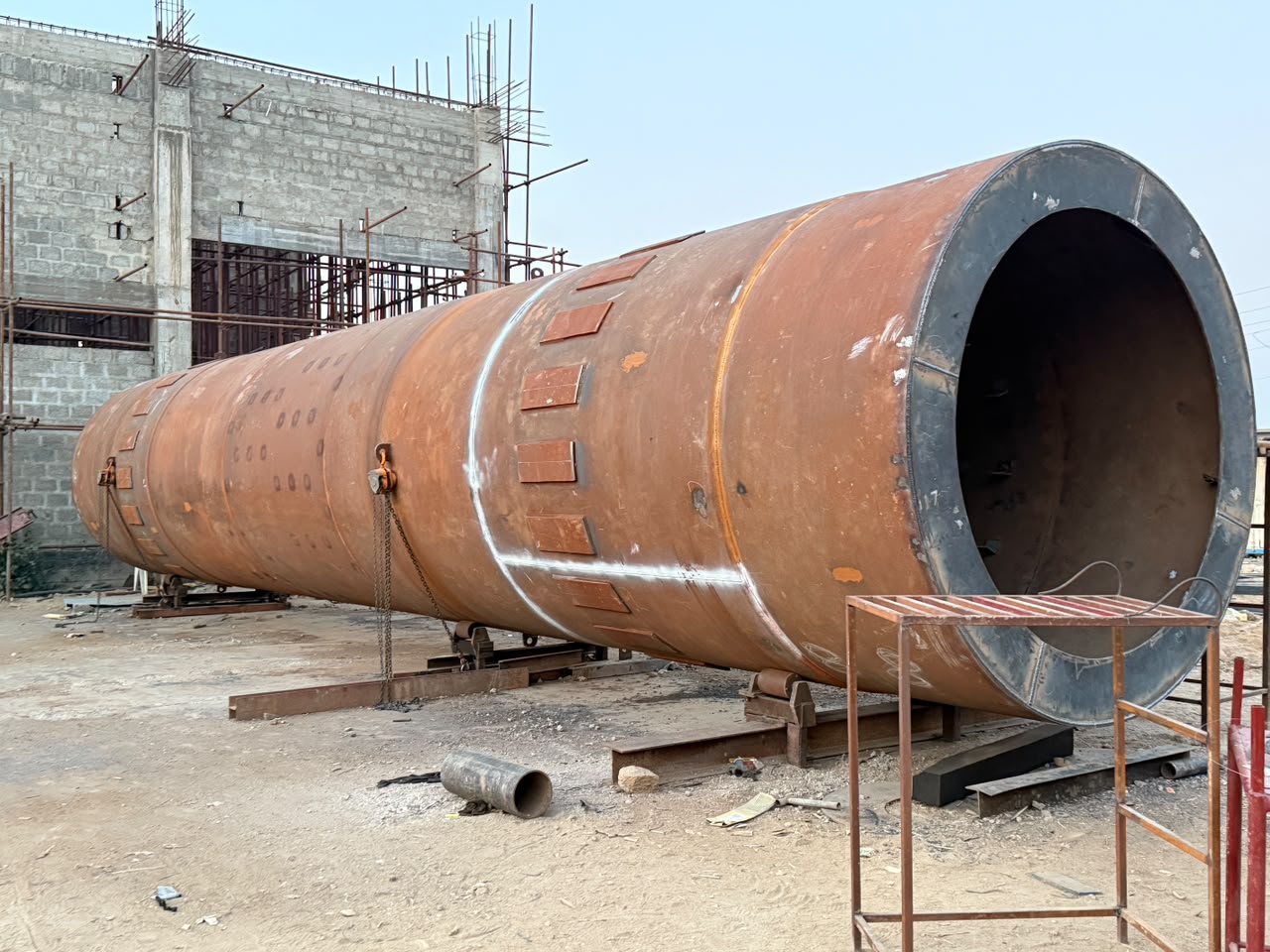 Large fabricated pressure vessel shell staged at the fabrication yard